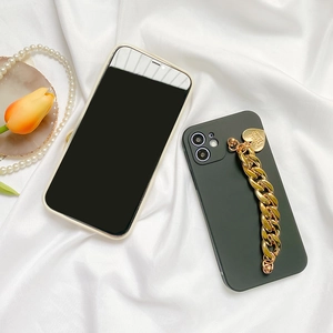 Detail of premium silicone phone case with chunky gold chain link and heart pendant