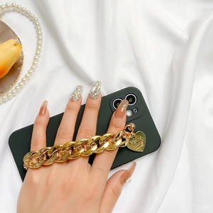 Detail of luxury gold alloy phone chain strap featuring a heart pendant and chunky link