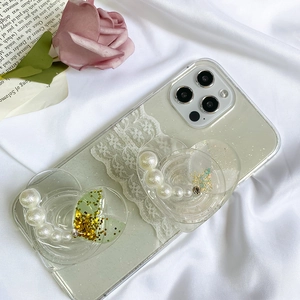 Detail of glitter phone case featuring pearl heart and gold foil mermaid style sequins