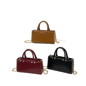 Minimalist glossy patent leather tote bags in caramel, burgundy and black with gold chains