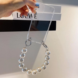 Detailed view of clear phone case with large pearl wrist strap and silver metal clasps