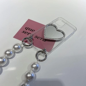 Detail view of transparent soft phone case with heart mirror and large pearl lanyard