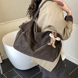 Vintage large capacity brown leather tote bag with a cute plush doll charm