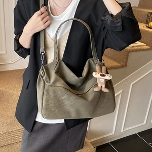 Minimalist grey-green suede tote bag for women with a cute plush charm and crossbody strap