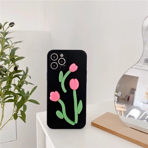 Close-up of 3D pink tulip decorations on a black matte iPhone case with floral details
