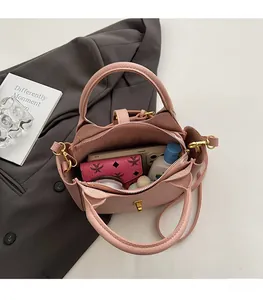 Detailed interior of pink pebble leather bucket bag showing storage capacity and hardware