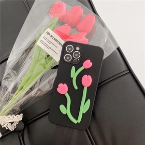 Close-up of black silicone case with 3D pink tulip decor on leather background