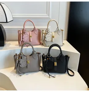 Litchi pattern bucket bags in pink, white, gray, and black with cute puppy charms