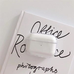 Minimalist clear acrylic protective case for AirPods Pro on a white book aesthetic background