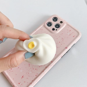 Close-up of a creative bun squishy phone grip being squeezed for stress relief