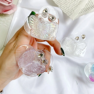 Close-up of heart-shaped resin phone socket with butterfly relief and rhinestones