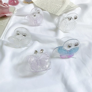 Close-up of butterfly phone grips with rhinestones on transparent heart bases
