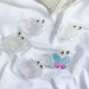 Detailed view of heart-shaped glitter phone grips with butterfly resin and rhinestones