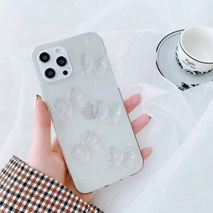 Sparkly clear iPhone 16 Pro Max case with 3D bows and silver glitter decoration