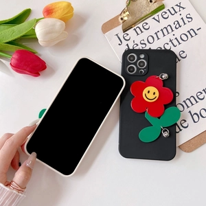 Detail of 3D red sunflower phone case with smiley face on matte black iPhone cover