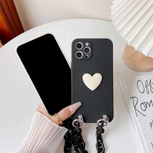 Close-up of black iPhone case with 3D white heart and chunky acrylic crossbody chain strap