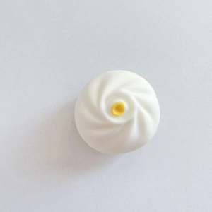 Detailed top view of a white custard bun phone grip with realistic silicone texture