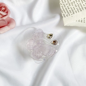 Macro view of transparent heart phone grip with purple butterfly and rhinestone inlay