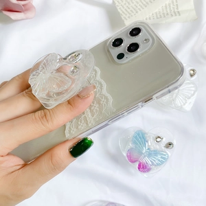 Macro view of clear butterfly heart phone socket with rhinestones on transparent case