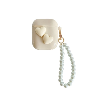 Creamy white heart AirPods case with elegant pearl wrist strap in minimalist style