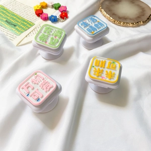 Close-up of cute telescopic phone socket stands with colorful inspirational quotes