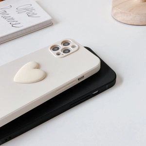 Detail view of iPhone case with 3D heart design and matte black silicone finish