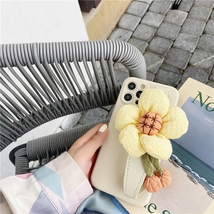 Detail of iPhone case with 3D fabric sunflower and stylish leather hand strap