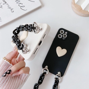 Detail showing iPhone case with stylish 3D heart decor and chunky chain handle