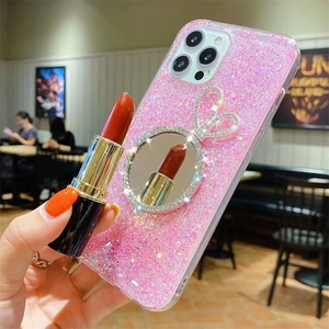 Detail of pink glitter iPhone case with rabbit ear makeup mirror and rhinestone accents