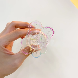 Detail of transparent glitter petal phone grip with colorful wave lines and acrylic texture