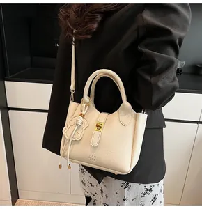 Detail of cream lychee texture bucket bag with PANTOR logo and elegant metal clasp