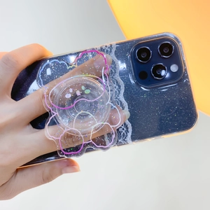 Close-up of glitter phone case with cute transparent bear grip and white lace trim detail