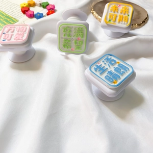 Set of four pastel square phone grips with 3D text in a stylish lifestyle arrangement