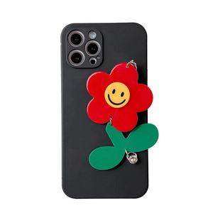 Minimalist black iPhone case with vibrant 3D sunflower and yellow smiley face pendant