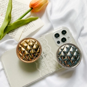 Detailed view of dual metallic grid pop sockets on a glitter lace phone case for women