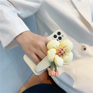 White iPhone case with a large 3D yellow fabric sunflower wrist strap for easy grip