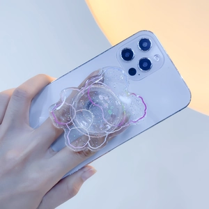 Detail of cloud-shaped glitter phone grip tok showing expanding acrylic airbag on smartphone