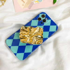 Detail of blue checkerboard phone case with textured gold molten metal finger grip