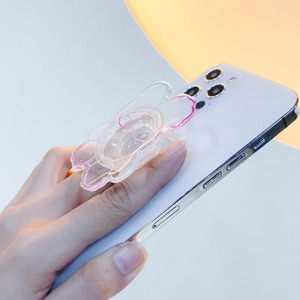 Close-up of a clear resin cloud phone socket with glitter and pink gradient edges