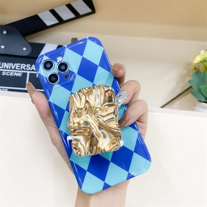 Detail of blue checkerboard phone case with a gold crinkled metal folding socket