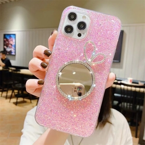 Pink glitter iPhone case with rabbit ear rhinestone mirror held in hand at a cafe