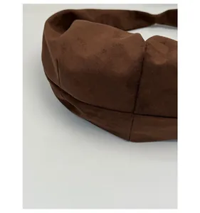 Detail view of the reinforced bottom stitching on the brown suede leopard tote bag