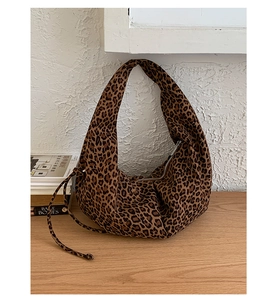 Detail of leopard print hobo bag showing the faux suede texture and decorative drawstring