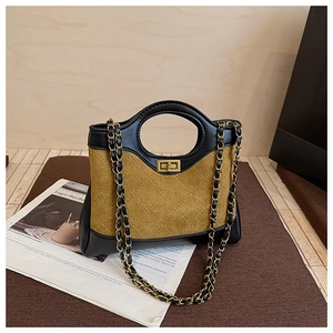 Close-up of the vintage quilted leather patchwork bag with a golden turn-lock closure