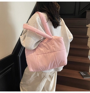 Borsa tote rosa trapuntata vista laterale che mostra la texture soffice sul modello