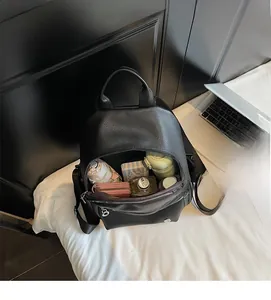 Internal view of the black pebbled leather backpack showing its spacious storage capacity