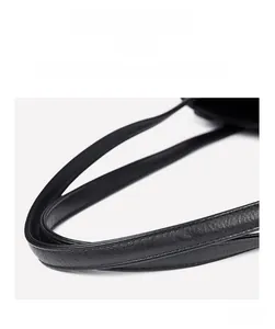 Close-up of black lychee grain leather handles with durable reinforced stitching