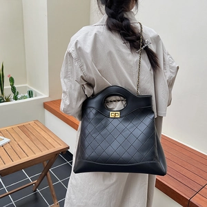 Chic quilted black chain crossbody bag with circular cutout handle and golden twist lock