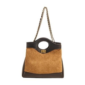 Brown and black quilted crossbody bag with round handle and gold chain strap