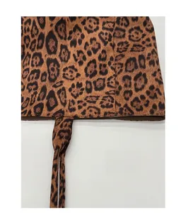 Detailed macro view of vintage leopard print suede texture and tidy stitching on tote bag
